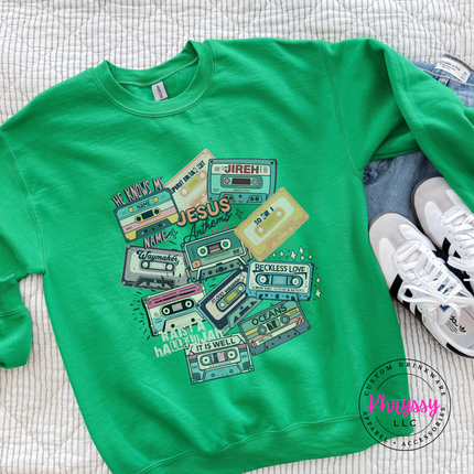 irish green heavyweight crewneck printed with retro worship anthem cassettes.
