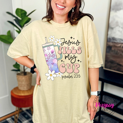 Banana garment-dyed tee with a floral tumbler and Jesus Fills My Cup script.