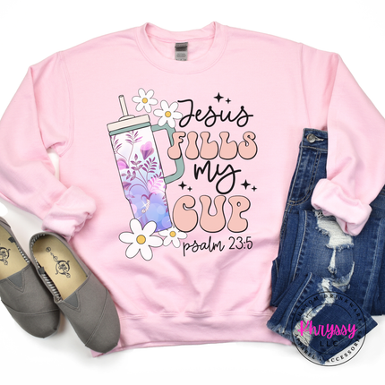 Light pink crewneck with a floral tumbler and Jesus Fills My Cup script.