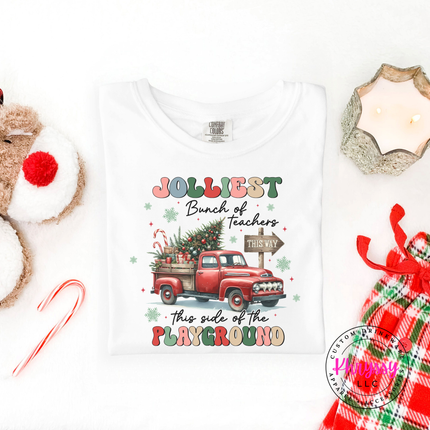 Flat lay of the Jolliest Teachers truck Christmas tee in White.