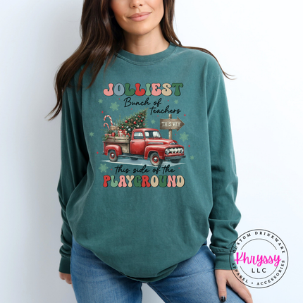 Model wearing the Jolliest Teachers truck long sleeve tee in Blue Spruce.