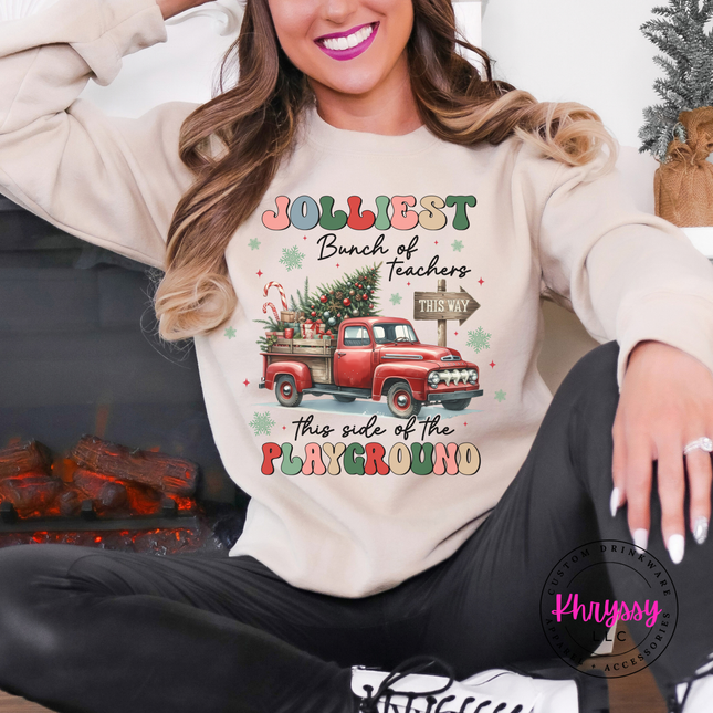 Close up of the Jolliest Teachers truck art on a Sand crewneck sweatshirt.

