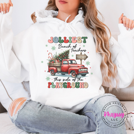 Flat lay of the Jolliest Teachers truck Christmas hoodie in White.
