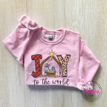 Flat lay of the Joy To The World Christmas crewneck sweatshirt in Light Pink.