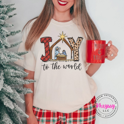 Ivory tee featuring a plaid and leopard Joy nativity design.