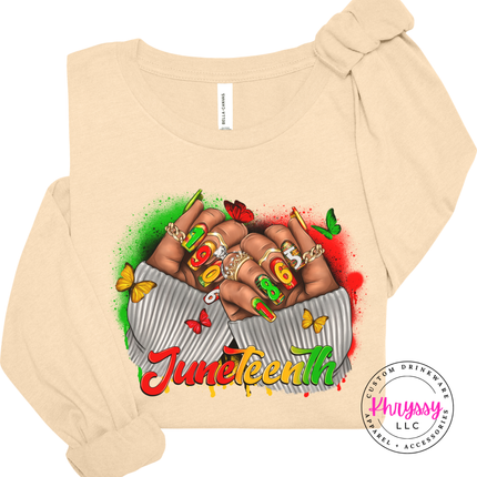 Soft cream long sleeve tee showing a colorful Juneteenth 1865 fists design.