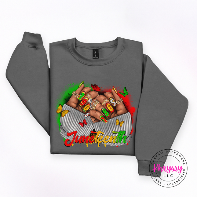 Charcoal crewneck sweatshirt featuring a vivid Juneteenth 1865 fists graphic.