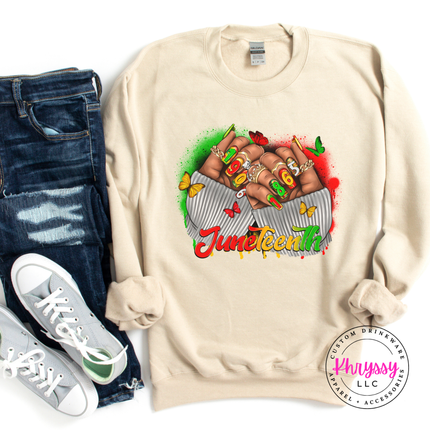 Sand crewneck sweatshirt with a red gold green Juneteenth 1865 fists design.