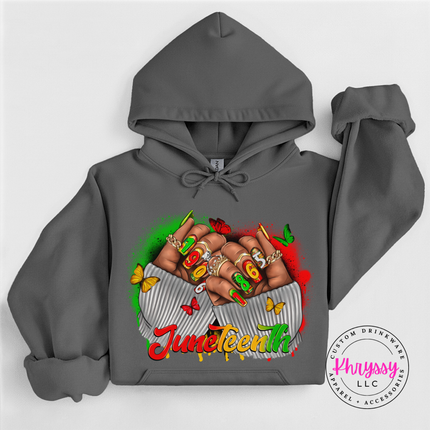 Charcoal hoodie showing a bold Juneteenth 1865 raised fists print.