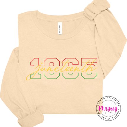 Soft cream long sleeve tee showing a colorful Juneteenth 1865 varsity design.
