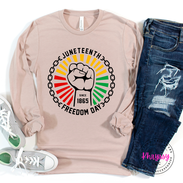 Heather Stone long sleeve tee showing a black raised-fist Pan-African Juneteenth graphic.