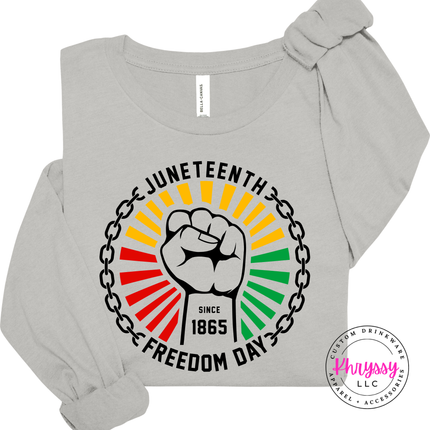 Silver long sleeve tee displaying a black raised-fist Juneteenth 1865 graphic.