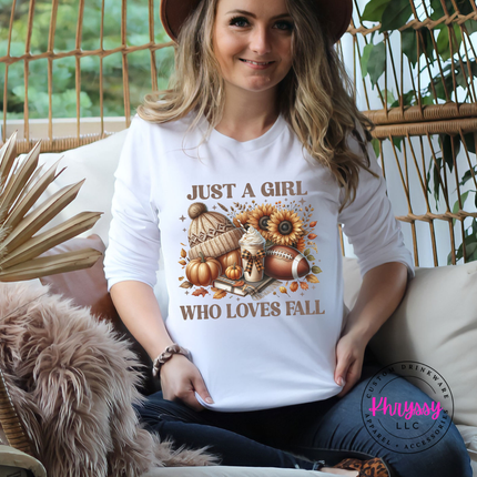 Woman wearing an white tee with a cozy fall icon collage design.
