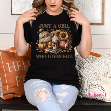 Woman wearing a Black graphic tee with a cozy fall icon collage design.
