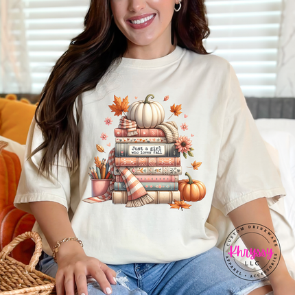Ivory tee with a hand-illustrated book stack and white pumpkin design.
