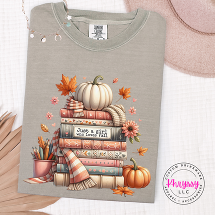 Sandstone tee with an illustrated stack of books and autumn florals.