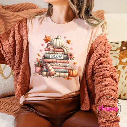 Heather Peach colored top with a bookish fall illustration and florals.