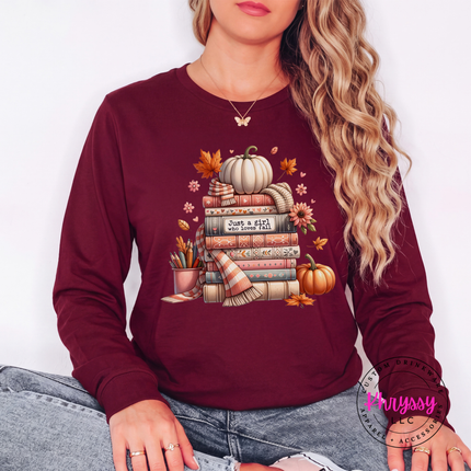 Maroon long sleeve tee with the autumn book lover pumpkin stack print