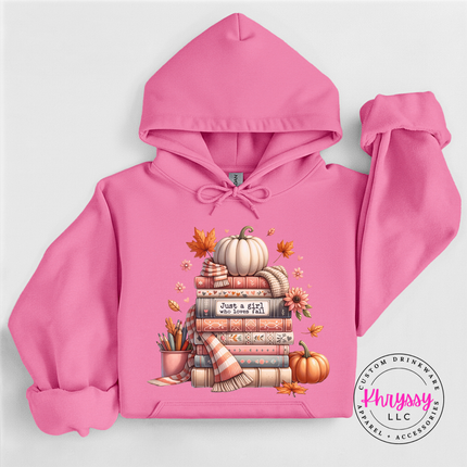 Woman wearing an Azalea pullover hoodie with a cozy book stack design.