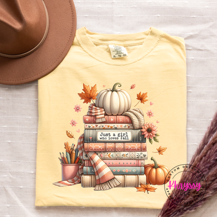 Butter colored graphic tee featuring an illustrated stack of books and florals.