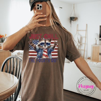 Brown tee featuring a sunglasses trash panda Fourth of July graphic