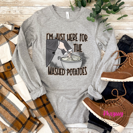 Woman wearing an Athletic Heather tee with a mashed potatoes design.