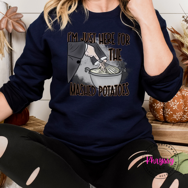 Navy crewneck sweatshirt featuring a witch's sleeve mixing potatoes.