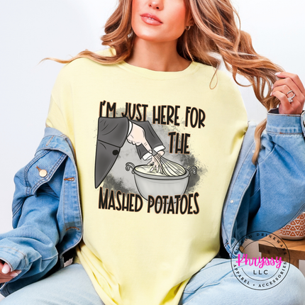 Woman wearing a banana graphic tee with a mashed potatoes witch design.