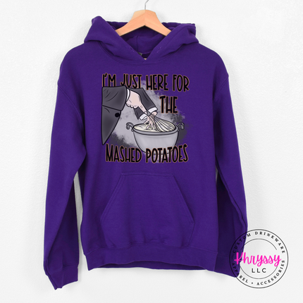 Purple crewneck sweatshirt featuring a witch's sleeve mixing potatoes.