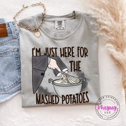 Granite tee featuring a witch's sleeve mixing a bowl of potatoes.