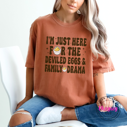 Woman wearing a yam Comfort Colors tee with a deviled eggs family drama graphic.