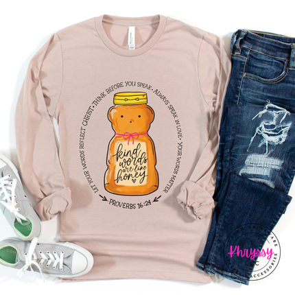 Pink long-sleeve shirt with honey bear graphic and text, paired with jeans and sneakers on a white background.