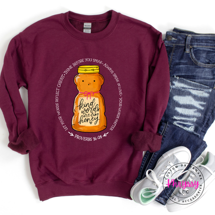 Maroon sweatshirt with a honey bear graphic and text, paired with jeans and sneakers on a white background.