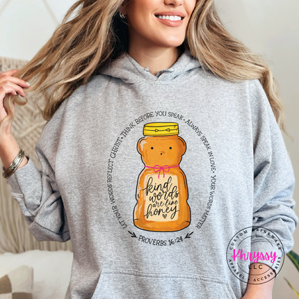 Person wearing a gray hoodie with a honey jar design and text.