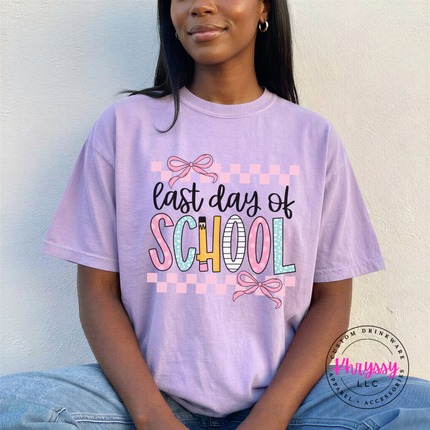 Orchid comfort tee showing pastel pinks and bows on a school design.