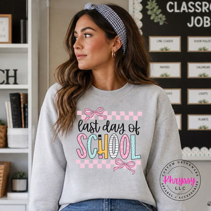 Ash grey crewneck sweatshirt with a pastel last day of school bow print.