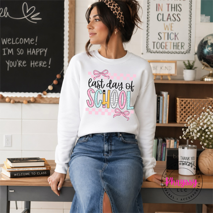 white grey crewneck showing pastel pinks and bows on a school design.