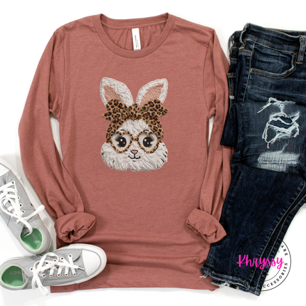 Mauve long-sleeve shirt with bunny design, jeans, and sneakers on a white background
