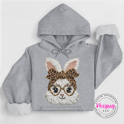 Gray hoodie with a bunny face design wearing a leopard print headband on a white background.