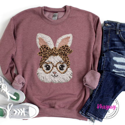 Maroon sweatshirt with bunny design wearing a leopard print bow, paired with jeans and sneakers on a white background.