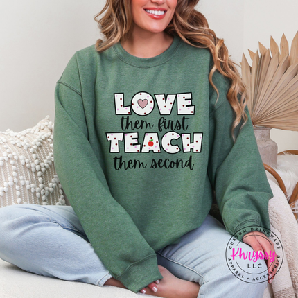 Soft Heather Sport Dark Green
Gildan crewneck featuring love them first teach them second polka dot teacher heart apple statement
