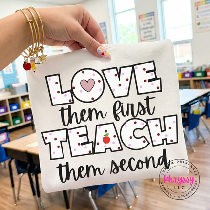 White teacher appreciation statement on Melon Comfort Colors tee with black polka dot lettering and heart apple detail