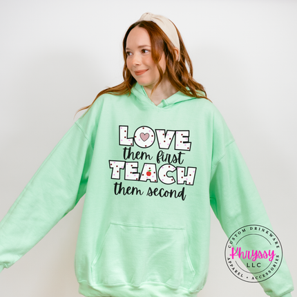 Love them first teach them second polka dot hoodie on mint Gildan with teacher heart and red apple detail