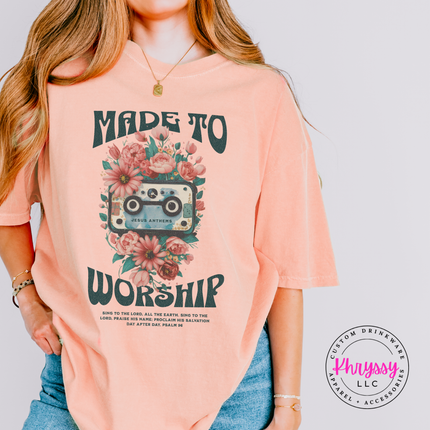 Peachy tee showing a retro Made To Worship cassette and flower design