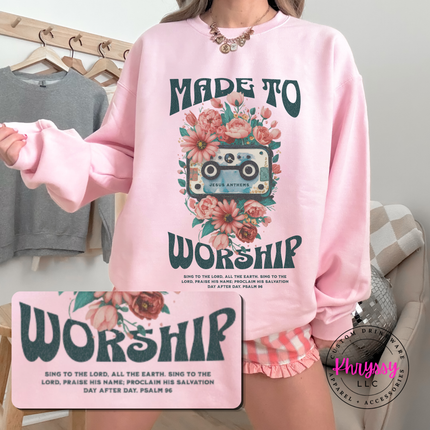 light pink crewneck sweatshirt showing the Made To Worship cassette illustration