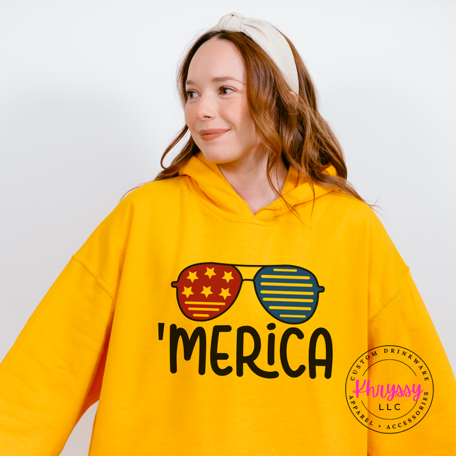 Gold pullover hoodie featuring red and blue shades with bold black lettering.