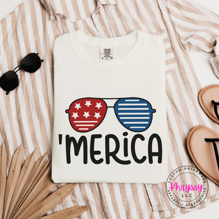 Ivory garment-dyed tee showing a star-and-stripe sunglasses summer graphic.