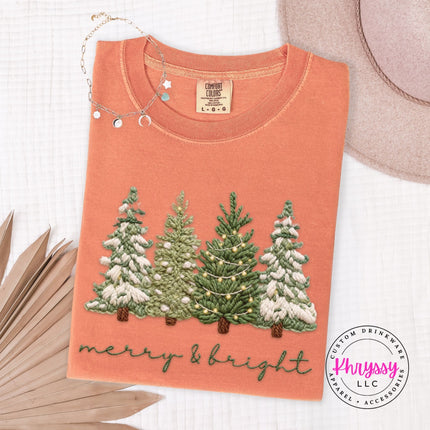 Terracotta Comfort Colors tee with a classic snowy Christmas trees graphic, flat lay view.