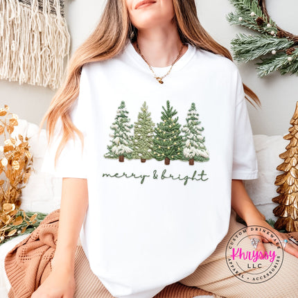 White Comfort Colors tee featuring an embroidery style evergreen trees and script design.
