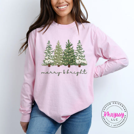 Blossom long sleeve tee with snowy evergreen trees and merry and bright script.